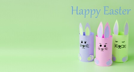 Paper craft.  Cheerful Easter bunnies stand on a bright background.  Front view banner, foreground.  Space for copy text.  Concept holiday bright easter.