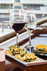 Rich gourmet plate of chicken with mushrooms and red wine with a city behind