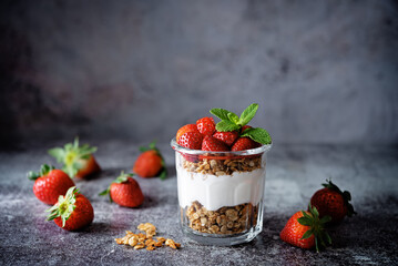 Strawberry Greek yogurt granola parfait in a glass