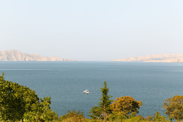 A small boat sailing in the Adriatic sea near Croatia coastline.