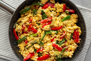 Homemade Scrambled Peppers and Eggs in a Pan, top view. Flat lay, overhead, from above.