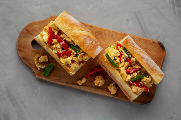Homemade Easter Pepper and Egg Sandwich on a rustic wooden board, top view. Flat lay, overhead, from above.