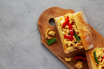 Homemade Easter Pepper and Egg Sandwich on a rustic wooden board, top view. Flat lay, overhead, from above.