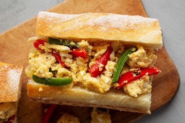 Homemade Easter Pepper and Egg Sandwich on a rustic wooden board, top view. Flat lay, overhead, from above. Close-up.