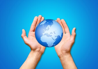 Concept of Earth Day. Hands hold a Globe.
