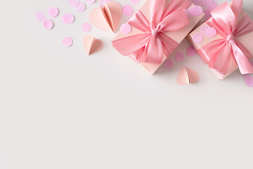 Pink boxes with confetti on grey background
