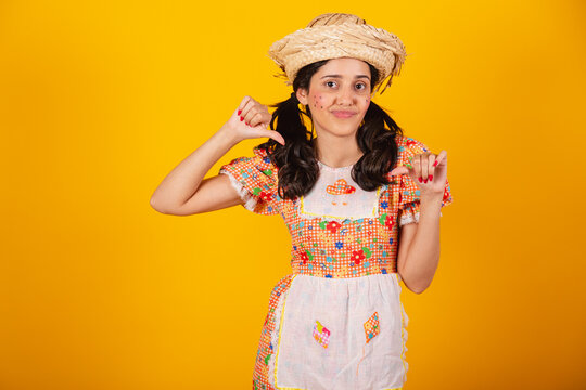 Beautiful Brazilian woman, with June party clothes, dislike sign, negative.