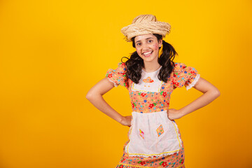 Beautiful Brazilian woman, with June party clothes, smiling and posing for a photo.