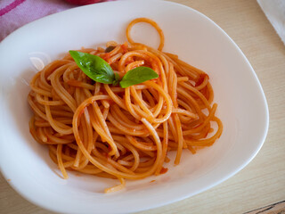 Italian Pasta Spaghetti alla chitarra, spaghetti quadri, tonnarelli con sugo di pomodoro and basil leaf