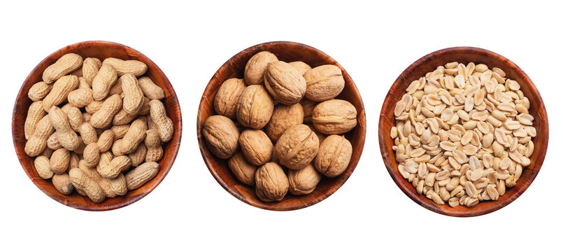 Peanuts background. Vegetarian diet food. Nuts in shells inside round wooden bowl isolated. Snacks in a bowl. Healthy party snack. Hulled peanuts without shell. Walnuts diet.