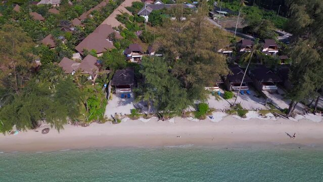 luxury bungalow resorts on a white sandy beach. Calm aerial view flight drone