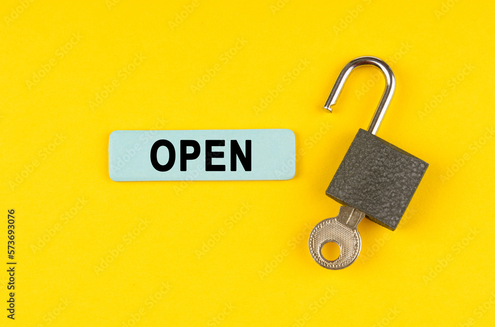 Poster On the yellow surface lies an open lock with a key, next to it is a sticker with the inscription - open