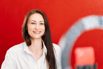 a brunette woman works at the computer and conducts a live broadcast 
