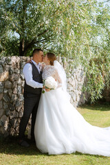 young couple the groom in a plaid suit and the bride in a chic white dress