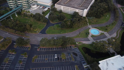 Ariel View sunset, sunset over empty parking lot,  
with random cars road