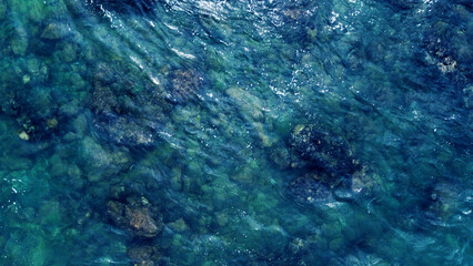Fototapeta na wymiar Blue water texture. Top view of the ocean surface with waves