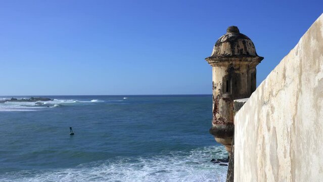Fort wall sentry box above the Caribbean Sea crashing waves. Bartizan or garita at Castillo San Felipe del Morro, San Juan, Puerto Rico. Icon appears on Puerto Rican license plates and quarters. 