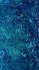 Blue water texture. Top view of the ocean surface with waves