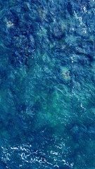 Blue water texture. Top view of the ocean surface with waves