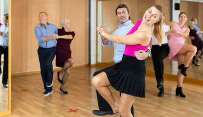 Obraz premium naughty girl with partner learn to dance incendiary dance jive dance class