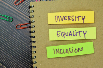 Concept of Diversity, Equality, Inclusion write on sticky notes isolated on Wooden Table.