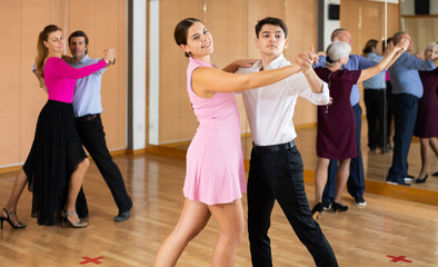 Fototapeta na wymiar smiling woman dancing at sport dance class slow waltz