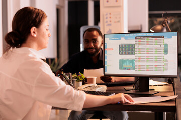 Corporate worker analyzing fund market statistics data on computer screen, looking at company investment revenue. Stock market monitoring website, financial analytics diagrams