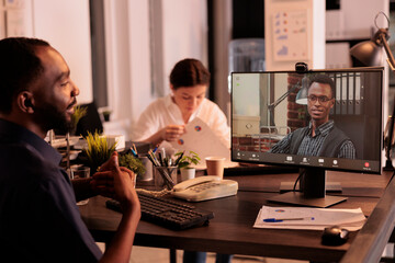 Remote coworkers talking on corporate videocall on computer, employees discussing company strategy on online business meeting. Team leader listening to colleague on videoconference