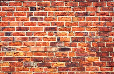 Weathered red brick wall background.