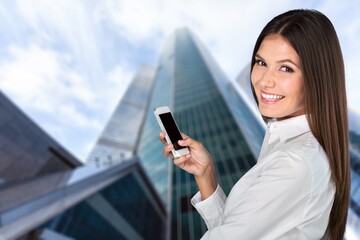 Fototapeta premium Young smart business person with phone on outdoors
