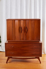 Vintage Mid-Century Modern Dresser. Retro Walnut Chest with Unique Doors. Interior view against a...