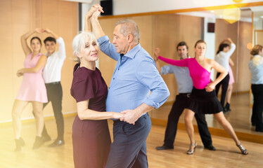 Fototapeta na wymiar older woman dancing slow couples rumba dance with her partner