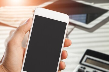 Hands hold a phone with a blank screen