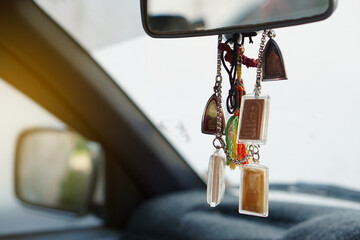 Closeup Buddha amulets hang  in  front console of the car. Concept, faith and belief for Buddhist...