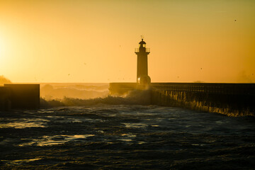 Fototapeta na wymiar Lighthouse during golden sunset at Atlantic ocean, Porto, Portugal.