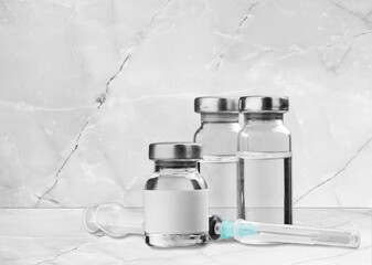 Glass medical ampules and bottle on hospital background