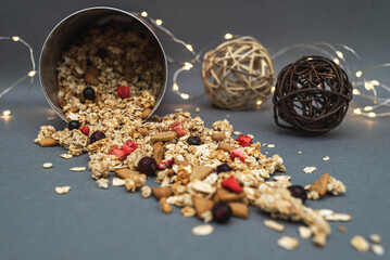 Baked fruit muesli with rattan balls scattered on the table. Homemade granola. Side view