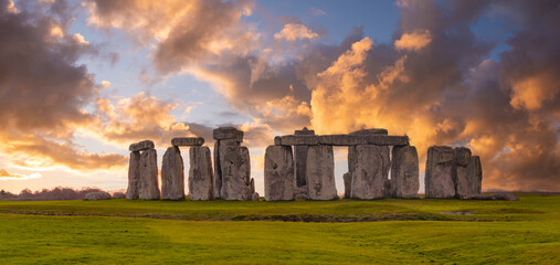 Amazing sunset at Stonehenge in England with dramatic sky and sun rays
