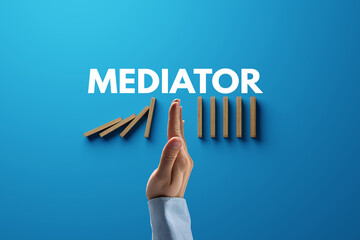 Dominoes falling over, stopped by hand and mediator. The concept of mediation and the use of...