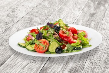 Fresh tasty salad with vegetables in bowl