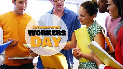 Animation of international workers day over diverse female and male coworkers talking in office - Powered by Adobe