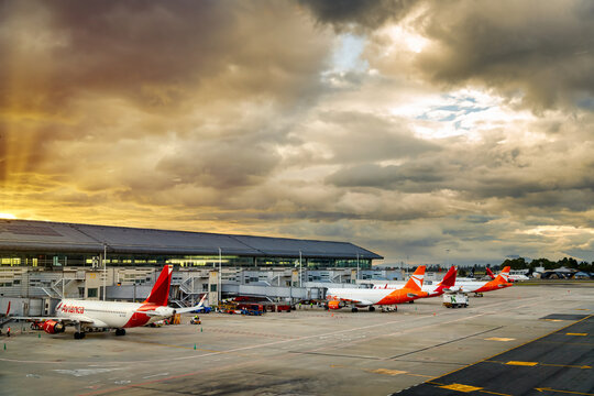 Bogota, Colombia - January 23, 2023: Avianca and Ultra planes parked in a terminal of El Dorado airport during sunset