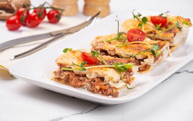 Sliced lasagna on a white platter