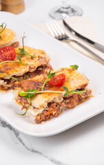 Sliced lasagna on a white platter