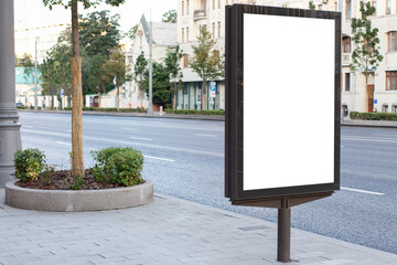 Vertical billboard advertising in the city. At the round flower bed. Mock-up.