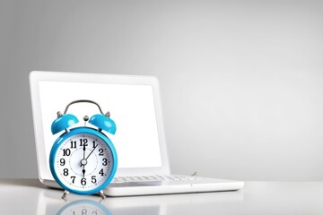 laptop computer and retro alarm clock