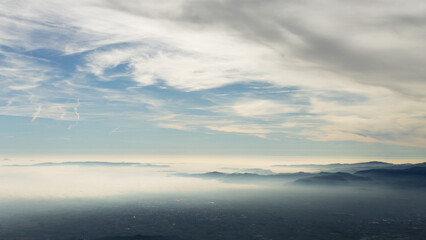 Fototapeta na wymiar Sky with clouds over foggy plain