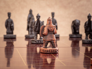 Chinese chess bronze pawn faces opponent.