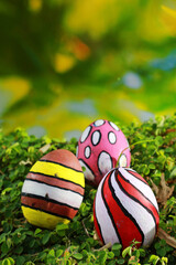 Colorful easter eggs on green grass with bokeh background
