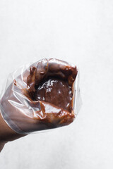 a piping bag filled with thick chocolate batter, thick chocolate cake batter